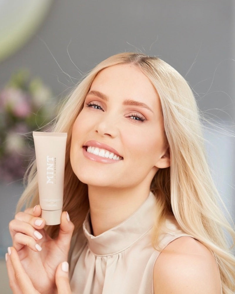 MINT by Dr. Mintcheva Gumcare with Vitamine E product held by model